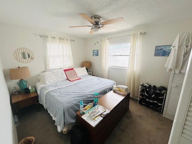 8409 43rd Ave W, Bradenton, FL 34209 - carpeted bedroom featuring ceiling fan and a textured ceiling