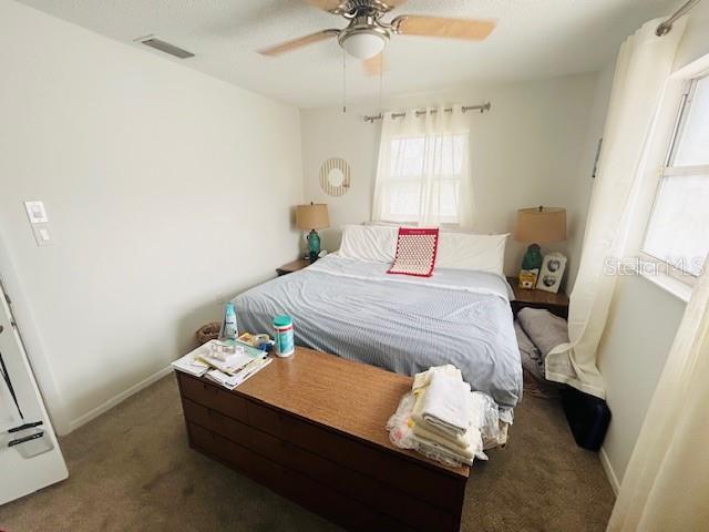 8409 43rd Ave W, Bradenton, FL 34209 - carpeted bedroom featuring baseboards and a ceiling fan