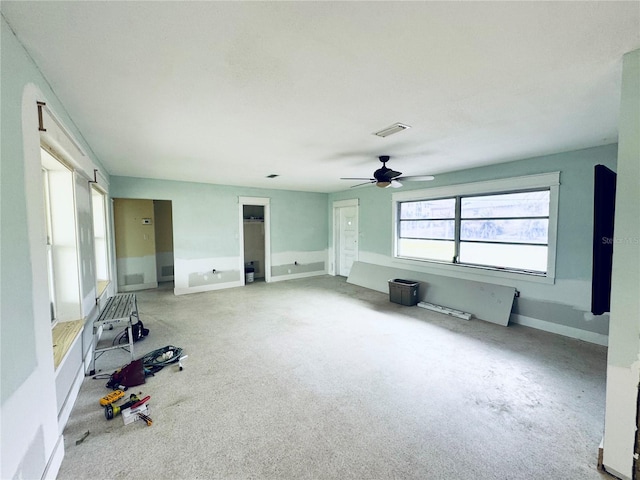 104 Pops Ln, Nokomis, FL 34275 - unfurnished living room with ceiling fan, baseboards, and carpet