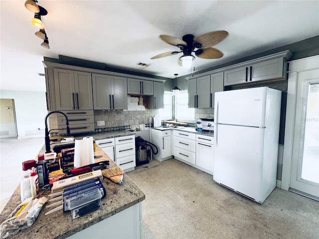 104 Pops Ln, Nokomis, FL 34275 - kitchen featuring freestanding refrigerator, backsplash, ceiling fan, and gray cabinetry