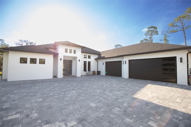 6713 Taneytown St, North Port, FL 34291 - view of front of house featuring a garage, stucco siding, and decorative driveway
