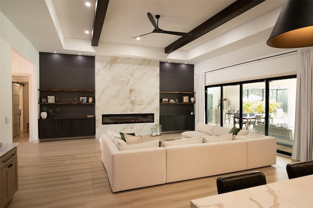 6713 Taneytown St, North Port, FL 34291 - living room featuring light wood-style floors, beamed ceiling, ceiling fan, recessed lighting, and a premium fireplace