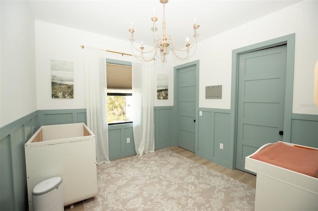 6713 Taneytown St, North Port, FL 34291 - bathroom with a chandelier, wood finished floors, a wainscoted wall, and a decorative wall