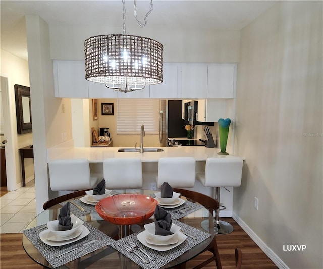 2124 N Tamiami Trl Unit 108, Sarasota, FL 34234 - dining room featuring a chandelier and baseboards
