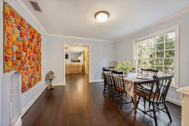 102 28th St W, Bradenton, FL 34205 - dining space featuring dark wood finished floors, baseboards, and ornamental molding