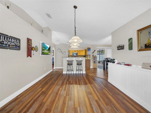 27 Sea Shark Path, Palm Coast, FL 32164 - living room with wood finished floors, vaulted ceiling, and baseboards