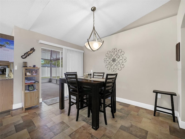 27 Sea Shark Path, Palm Coast, FL 32164 - dining space with vaulted ceiling, baseboards, dark stone finish floors, and a textured ceiling