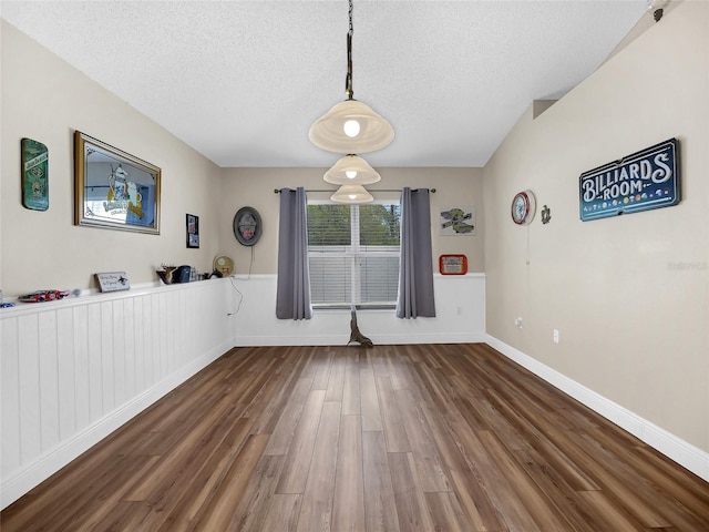 27 Sea Shark Path, Palm Coast, FL 32164 - unfurnished dining area with wood finished floors, a textured ceiling, and baseboards