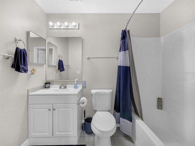 27 Sea Shark Path, Palm Coast, FL 32164 - bathroom featuring toilet, vanity, shower / bath combo with shower curtain, tile patterned floors, and baseboards