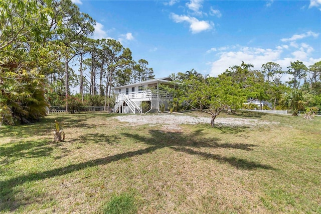 5403 Fleming St, Port Charlotte, FL 33981 - view of grassy yard with stairs and a wooden deck