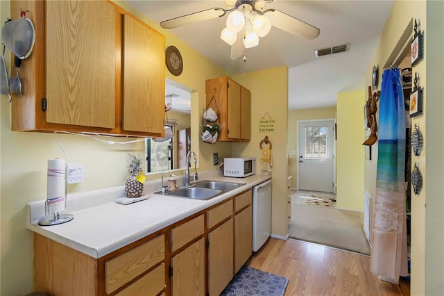 5403 Fleming St, Port Charlotte, FL 33981 - kitchen featuring a sink, white appliances, light wood finished floors, light countertops, and a ceiling fan
