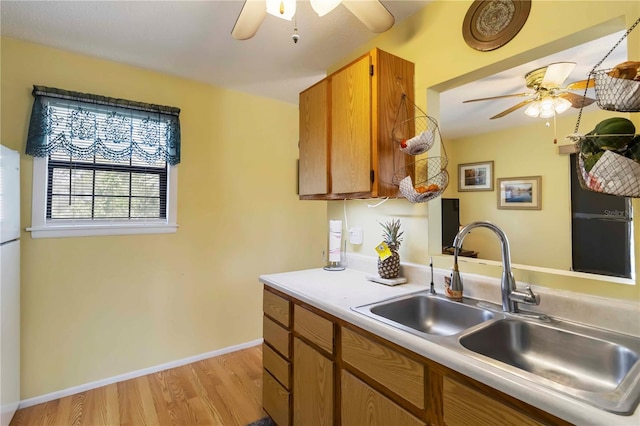 5403 Fleming St, Port Charlotte, FL 33981 - kitchen with a ceiling fan, a sink, light wood-style flooring, and light countertops
