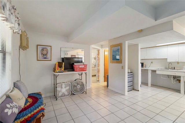 5403 Fleming St, Port Charlotte, FL 33981 - kitchen with light countertops, white cabinets, light tile patterned floors, a sink, and baseboards