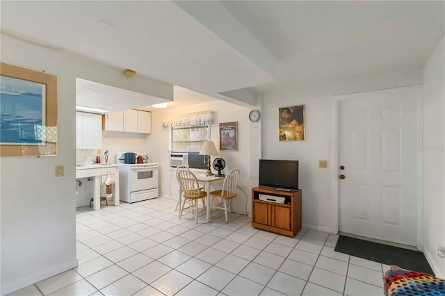 5403 Fleming St, Port Charlotte, FL 33981 - kitchen with white range, white cabinets, light tile patterned flooring, cooling unit, and light countertops