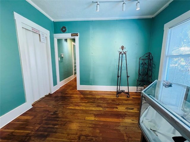 1019 10th Ave W, Bradenton, FL 34205 - unfurnished room with dark wood-style floors, ornamental molding, baseboards, and rail lighting