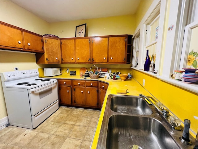 1019 10th Ave W, Bradenton, FL 34205 - kitchen with white appliances, a sink, and brown cabinetry