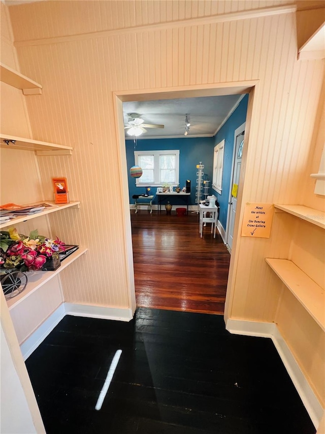 1019 10th Ave W, Bradenton, FL 34205 - hallway featuring wood-type flooring, baseboards, and wooden walls