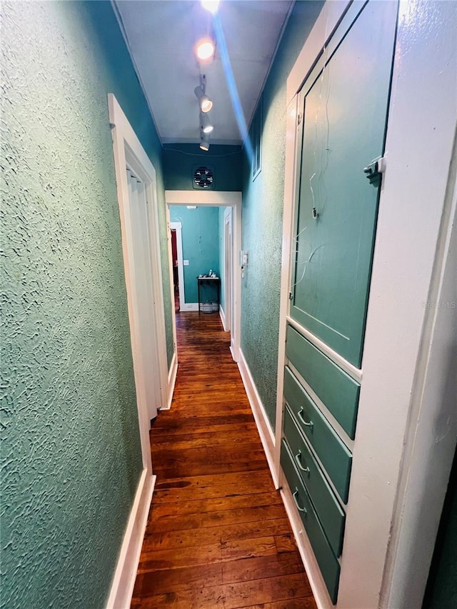 1019 10th Ave W, Bradenton, FL 34205 - hall featuring a textured wall, dark wood-style flooring, and baseboards