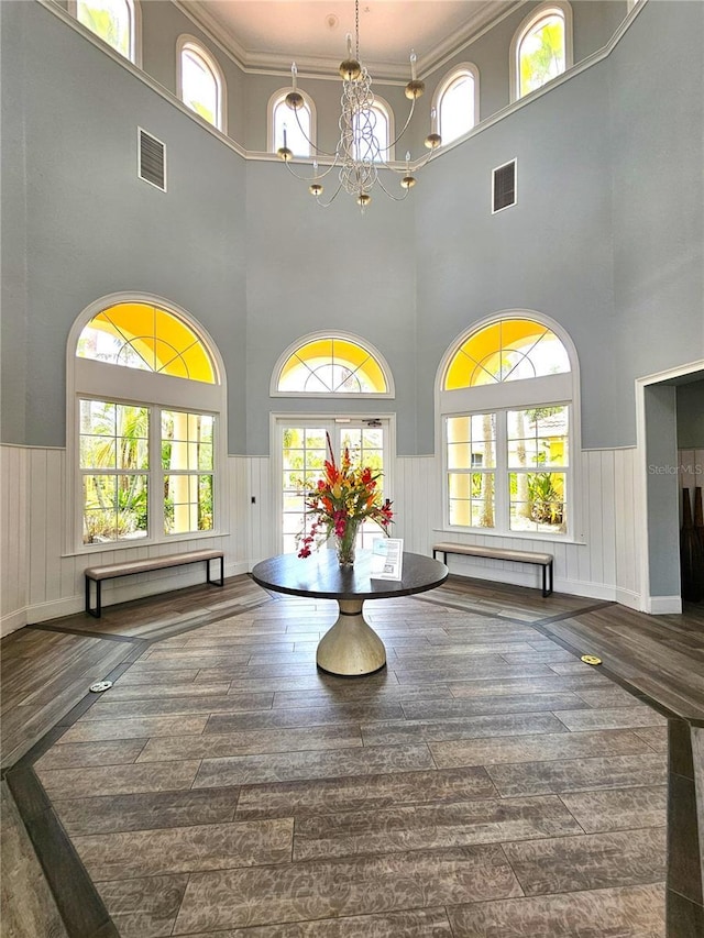 5711 Bentgrass Dr Unit 19-203, Sarasota, FL 34235 - community lobby with a high ceiling, wainscoting, and crown molding