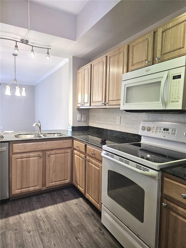 5711 Bentgrass Dr Unit 19-203, Sarasota, FL 34235 - kitchen featuring white appliances, crown molding, a sink, dark wood finished floors, and dark countertops