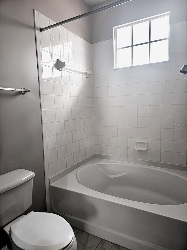 5711 Bentgrass Dr Unit 19-203, Sarasota, FL 34235 - bathroom featuring toilet, marble look tile flooring, and shower / washtub combination