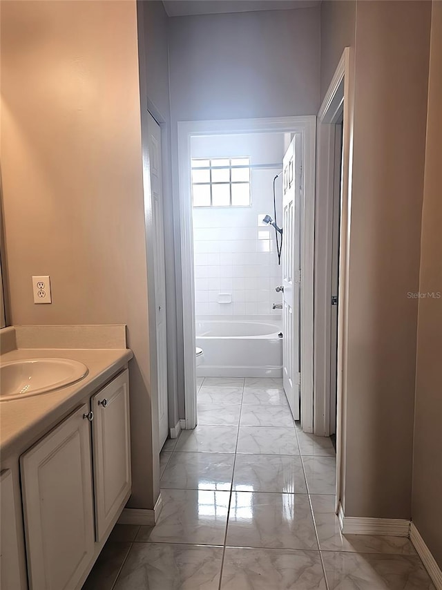 5711 Bentgrass Dr Unit 19-203, Sarasota, FL 34235 - full bathroom with marble finish flooring, baseboards, vanity, and  shower combination