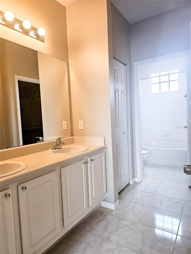 5711 Bentgrass Dr Unit 19-203, Sarasota, FL 34235 - full bathroom featuring a closet, marble look tile flooring, double vanity, toilet, and baseboards