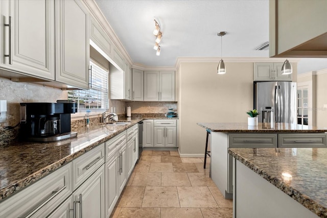 1723 Laramie St, Sarasota, FL 34231 - kitchen with stainless steel appliances, a sink, tasteful backsplash, and dark stone counters