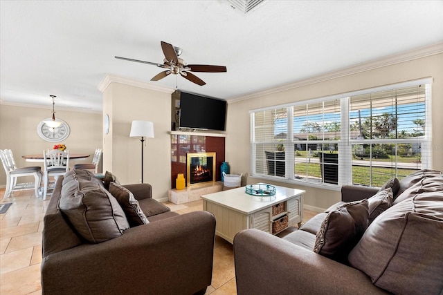 1723 Laramie St, Sarasota, FL 34231 - living room featuring crown molding, ceiling fan, a tile fireplace, baseboards, and light tile patterned floors