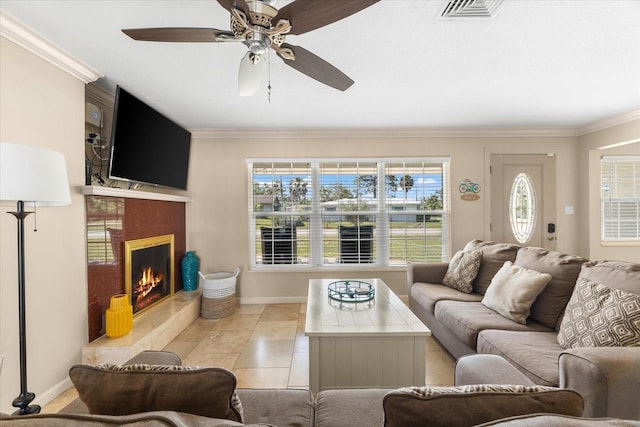 1723 Laramie St, Sarasota, FL 34231 - tiled living area with ornamental molding, a ceiling fan, baseboards, and a tiled fireplace