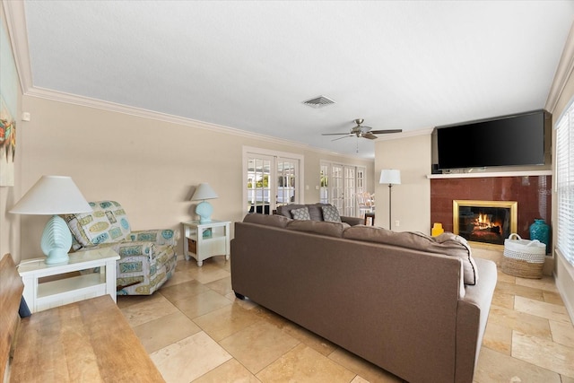 1723 Laramie St, Sarasota, FL 34231 - living room featuring a ceiling fan, crown molding, and a glass covered fireplace
