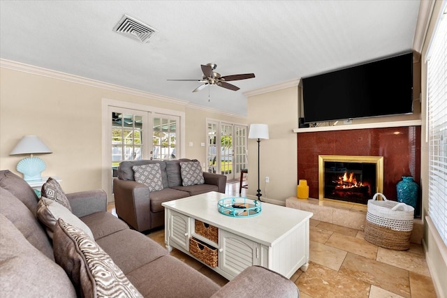 1723 Laramie St, Sarasota, FL 34231 - living room with french doors, crown molding, ceiling fan, a tile fireplace, and light stone finish flooring