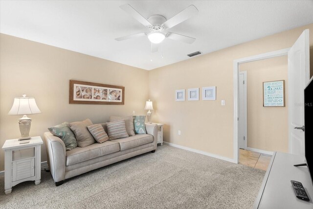 1723 Laramie St, Sarasota, FL 34231 - living room featuring a ceiling fan, light colored carpet, and baseboards