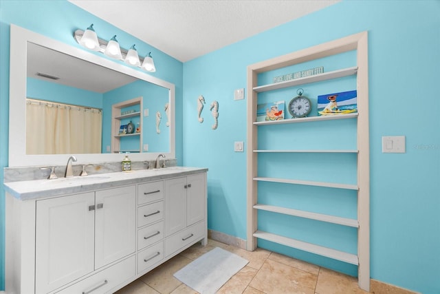 1723 Laramie St, Sarasota, FL 34231 - full bath with double vanity, a textured ceiling, baseboards, and tile patterned floors