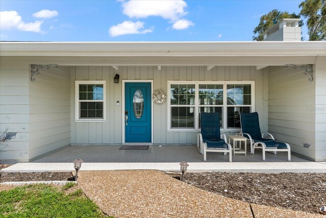 1723 Laramie St, Sarasota, FL 34231 - property entrance featuring covered porch and a chimney