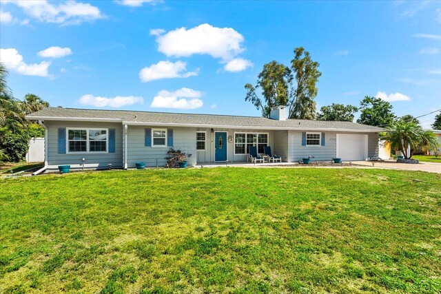 1723 Laramie St, Sarasota, FL 34231 - single story home featuring an attached garage, concrete driveway, a chimney, and a front lawn