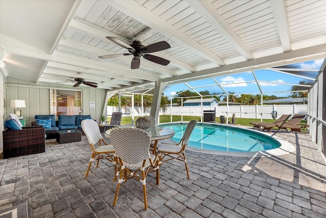 1723 Laramie St, Sarasota, FL 34231 - view of swimming pool with an outdoor living space, a fenced backyard, a patio, a ceiling fan, and a lanai