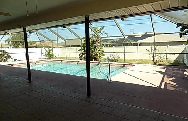 408 Fletcher St, Port Charlotte, FL 33954 - view of swimming pool with a lanai, a fenced backyard, and a patio area