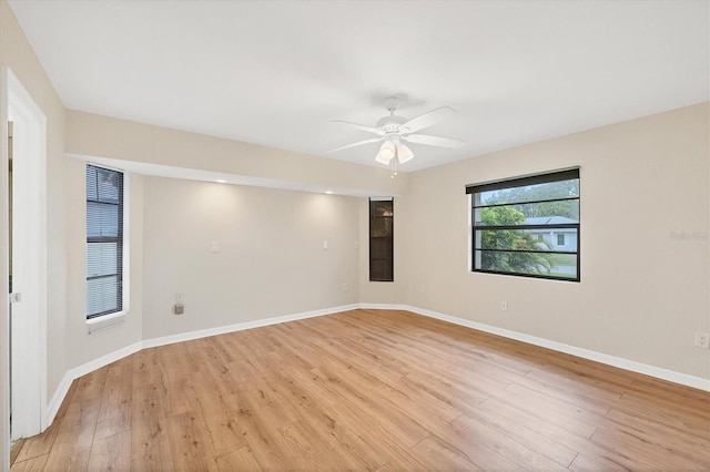 408 Fletcher St, Port Charlotte, FL 33954 - empty room with light wood-style floors, a ceiling fan, and baseboards