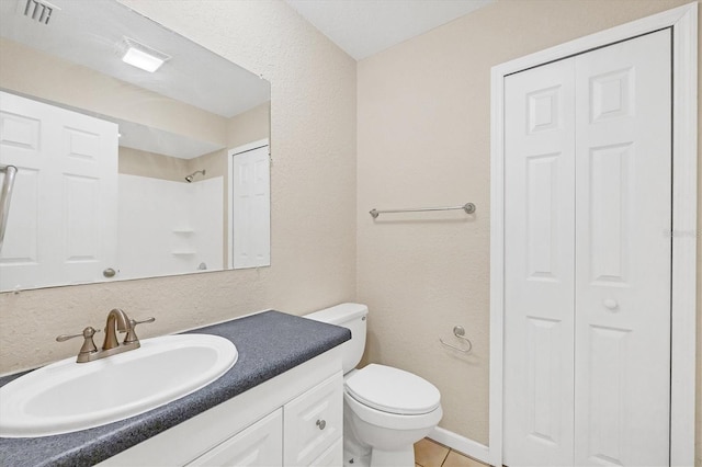 408 Fletcher St, Port Charlotte, FL 33954 - full bath featuring a closet, toilet, vanity, tile patterned floors, and a textured wall