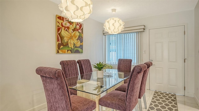 1838 Restful Dr Unit K-1, Bradenton, FL 34207 - dining space with a chandelier, baseboards, and light tile patterned floors