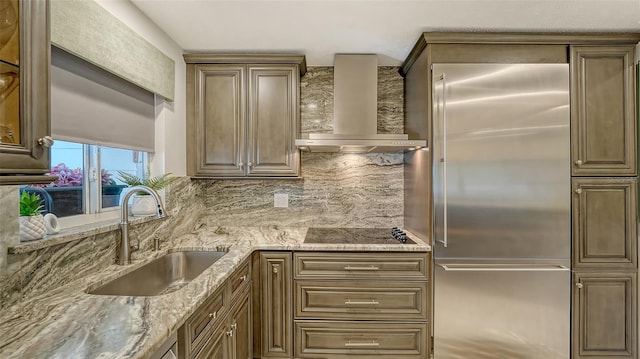 1838 Restful Dr Unit K-1, Bradenton, FL 34207 - kitchen featuring built in fridge, wall chimney range hood, a sink, black electric cooktop, and backsplash