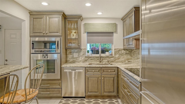 1838 Restful Dr Unit K-1, Bradenton, FL 34207 - kitchen featuring stainless steel appliances, a sink, light stone countertops, tasteful backsplash, and recessed lighting