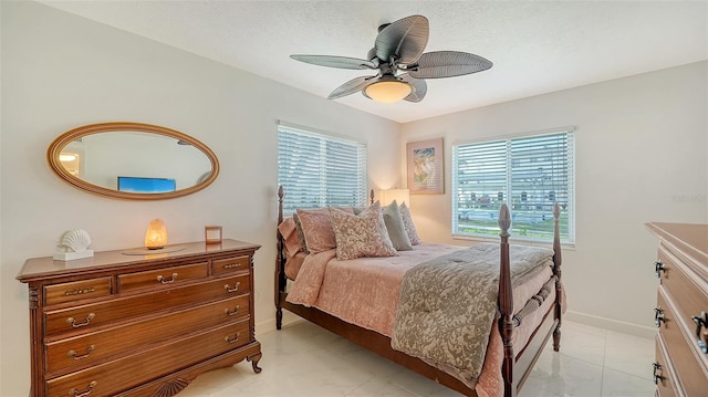 1838 Restful Dr Unit K-1, Bradenton, FL 34207 - bedroom with baseboards, ceiling fan, and a textured ceiling