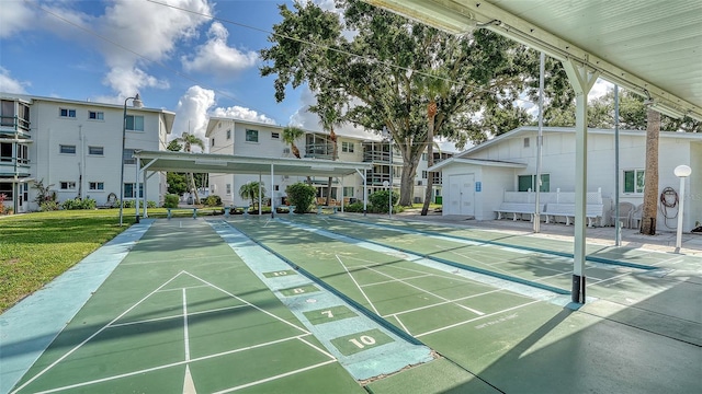 1838 Restful Dr Unit K-1, Bradenton, FL 34207 - view of community featuring shuffleboard and a lawn