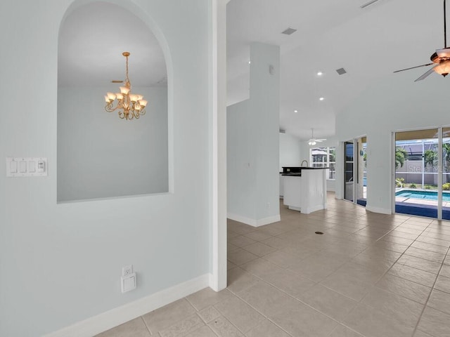 3616 SE 8th Pl, Cape Coral, FL 33904 - unfurnished room with ceiling fan, baseboards, vaulted ceiling, light tile patterned flooring, and a chandelier
