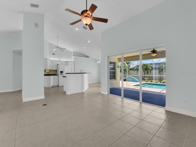 3616 SE 8th Pl, Cape Coral, FL 33904 - unfurnished living room with a ceiling fan, high vaulted ceiling, light tile patterned floors, baseboards, and recessed lighting