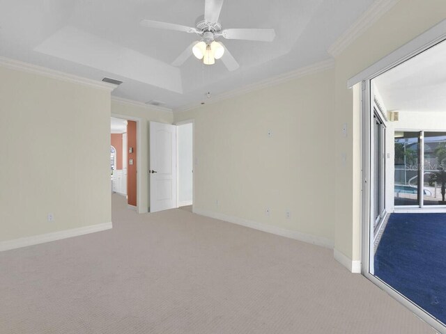 3616 SE 8th Pl, Cape Coral, FL 33904 - carpeted empty room featuring a raised ceiling, a ceiling fan, ornamental molding, and baseboards