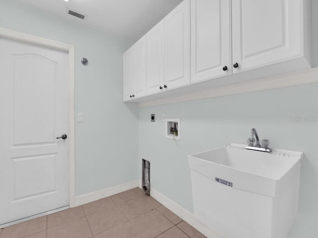 3616 SE 8th Pl, Cape Coral, FL 33904 - laundry room with cabinet space, electric dryer hookup, hookup for a washing machine, baseboards, and light tile patterned floors