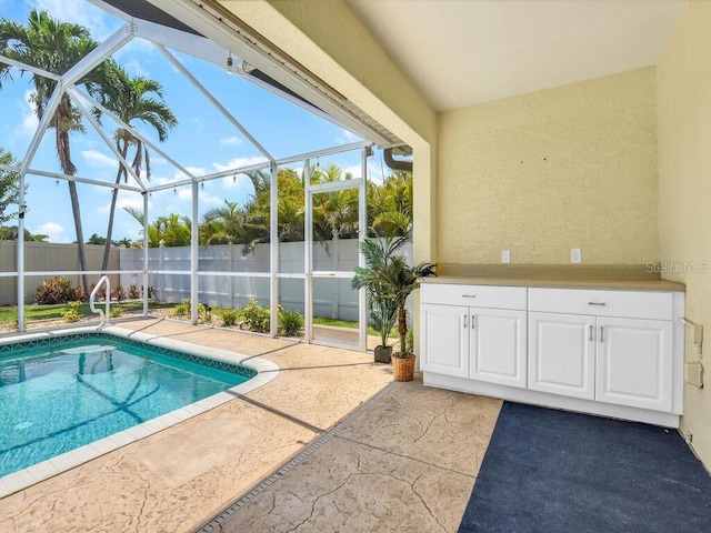 3616 SE 8th Pl, Cape Coral, FL 33904 - view of swimming pool with glass enclosure, a fenced backyard, and a patio